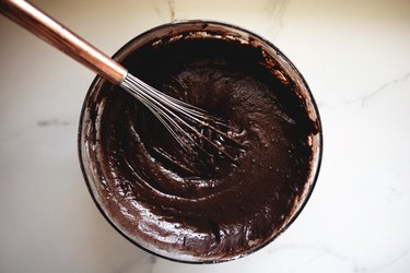 Mix in the liquid ingredients until the batter is thick and glossy.