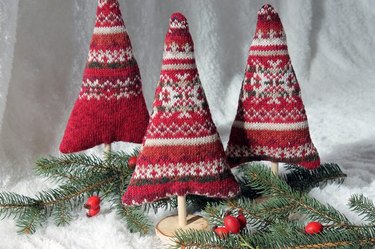 Three red sweater trees surrounded by branches