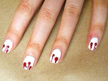 Lines of polish going from the tips of the nails to the center of the dots.