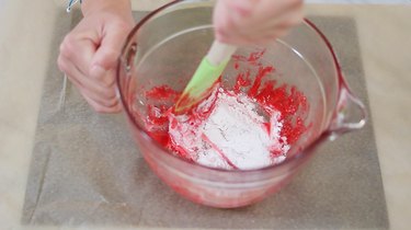 Stirring powdered sugar into melted Swedish fish