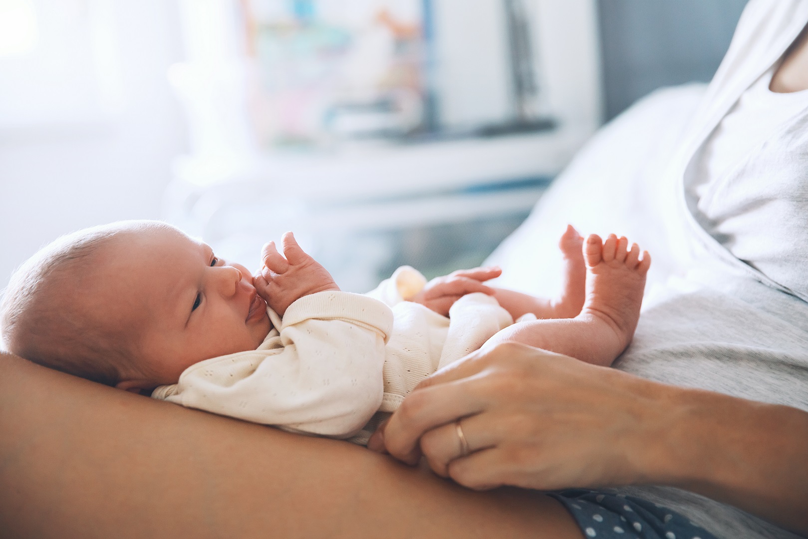 newborn baby on mom lap