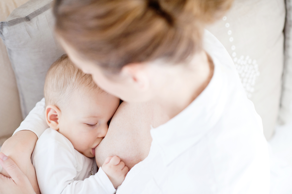 Mother looking down on baby breastfeeding